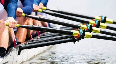 Close up of a men's quadruple skulls rowing team, seconds after the start of their race